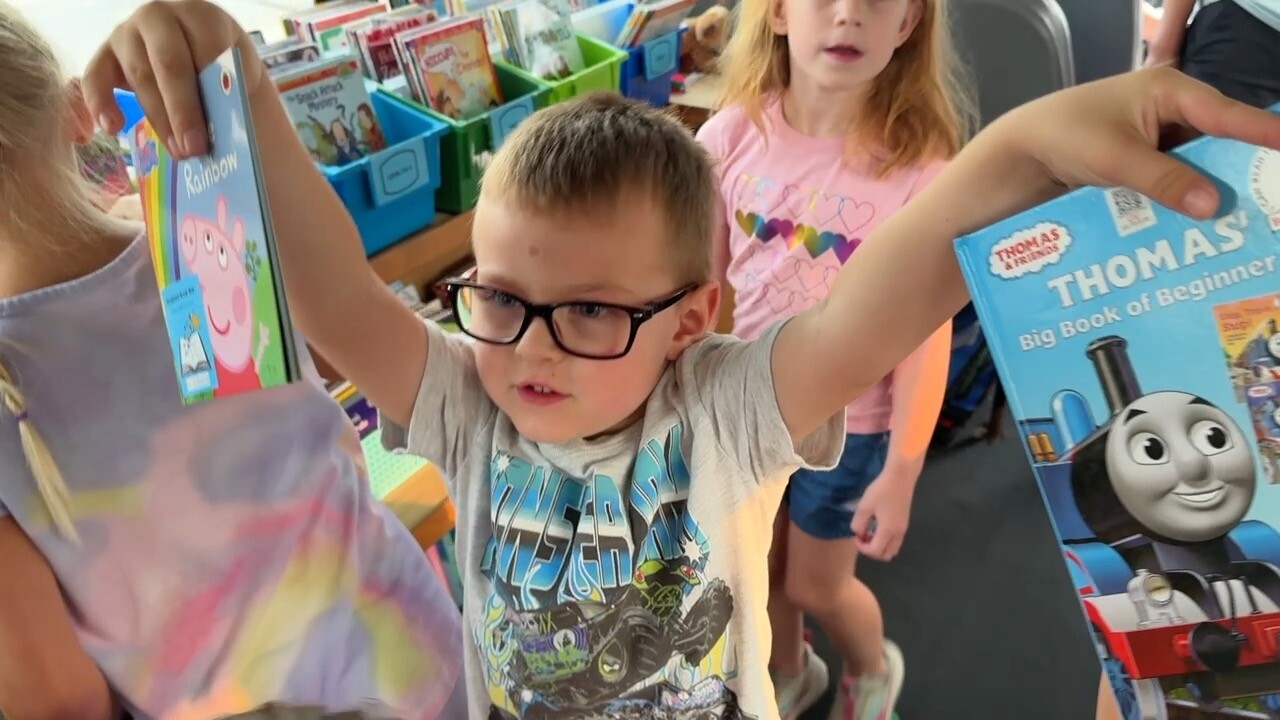 Kid holding books.jpg