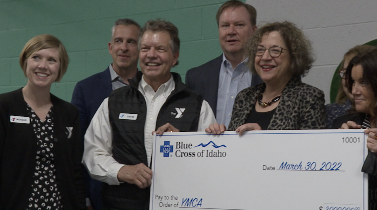 YMCA and Blue Cross of Idaho representatives smile during photo-op on Wednesday