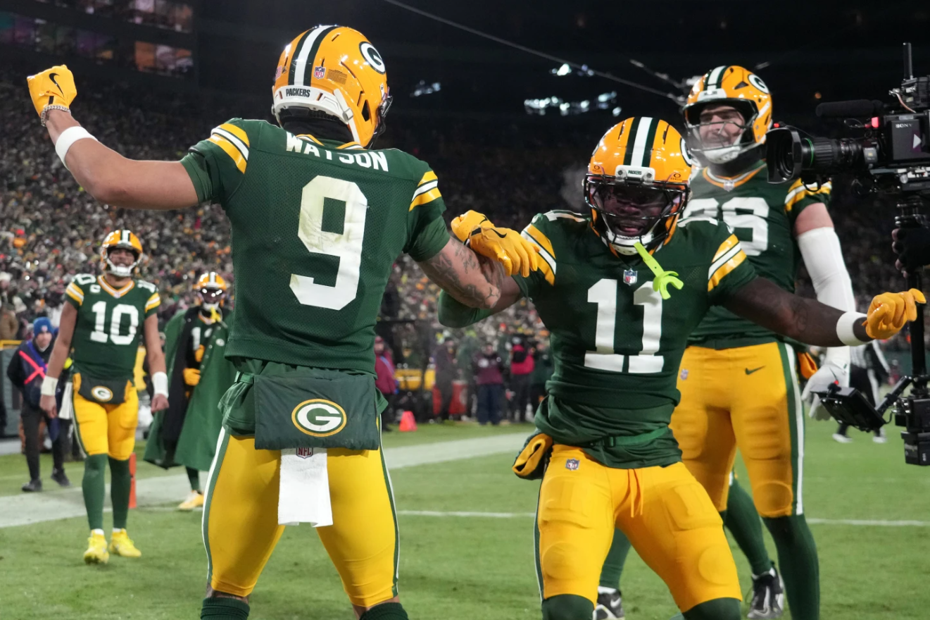 Green Bay Packers wide receiver Christian Watson (9) celebrates with wide receiver Jayden Reed (11) after scoring a touchdown against the Chicago Bears during the second half of an NFL football game Sunday, Dec. 7, 2025, in Green Bay.