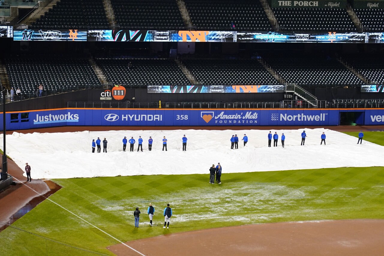 Grounds crews on field during rain delay between Miami Marlins and New York Mets at Citi Field, Sept. 29, 2023