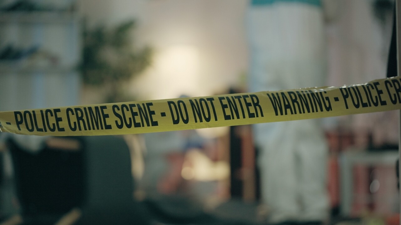Close-up,Of,Crime,Scene,Tape,,With,Forensic,Experts,Examining,The