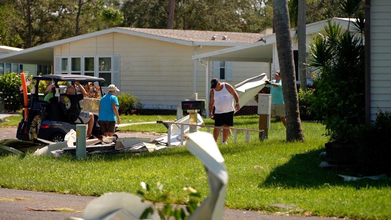 Neighbors helping neighbors clean up after the tornado's aftermath in Pine Lakes.