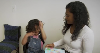 A mother sits with her daughter, who is suffering from a life-threatening condition.