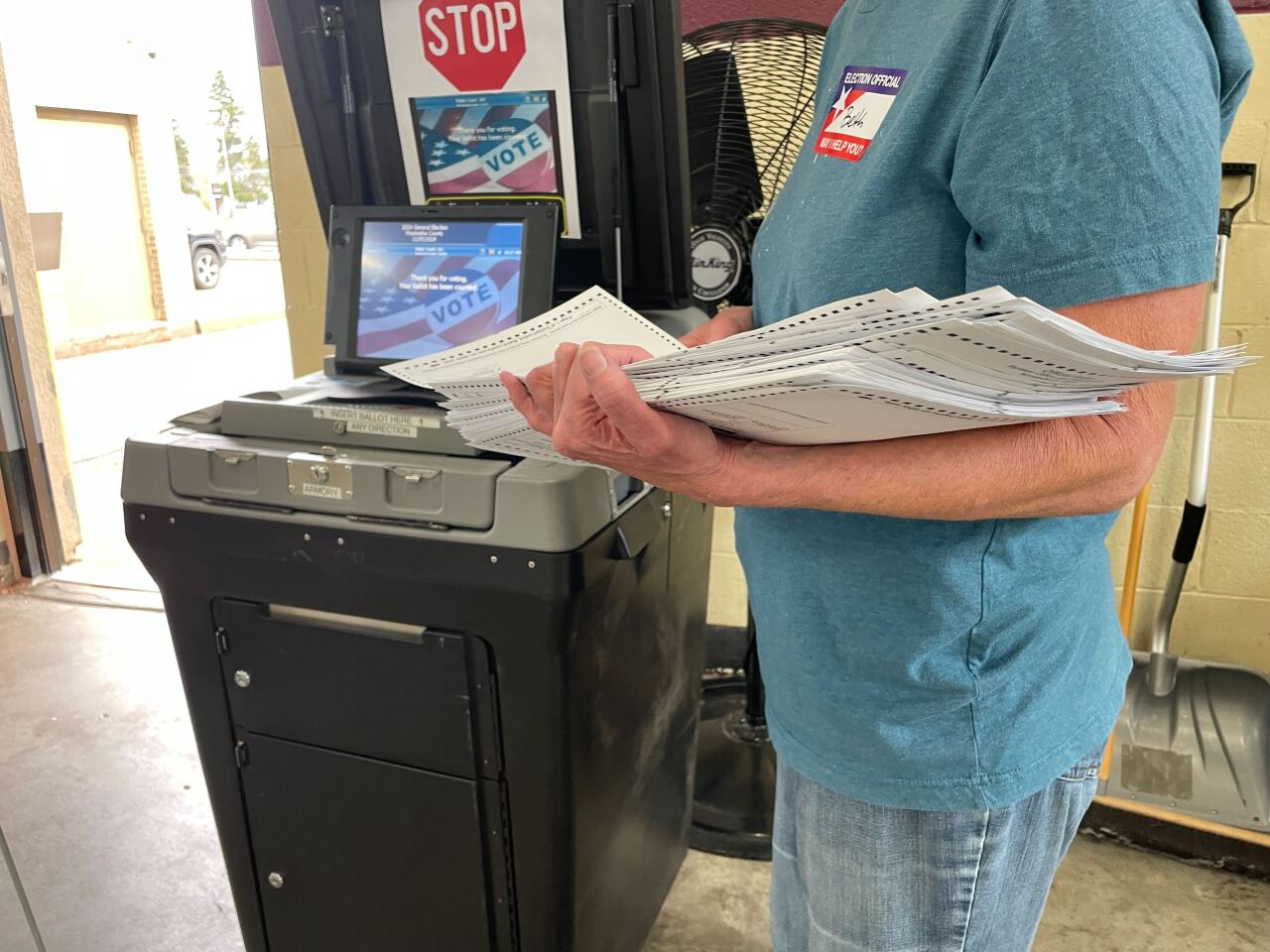 Waukesha County Election Officials run ballots through a tabulator.