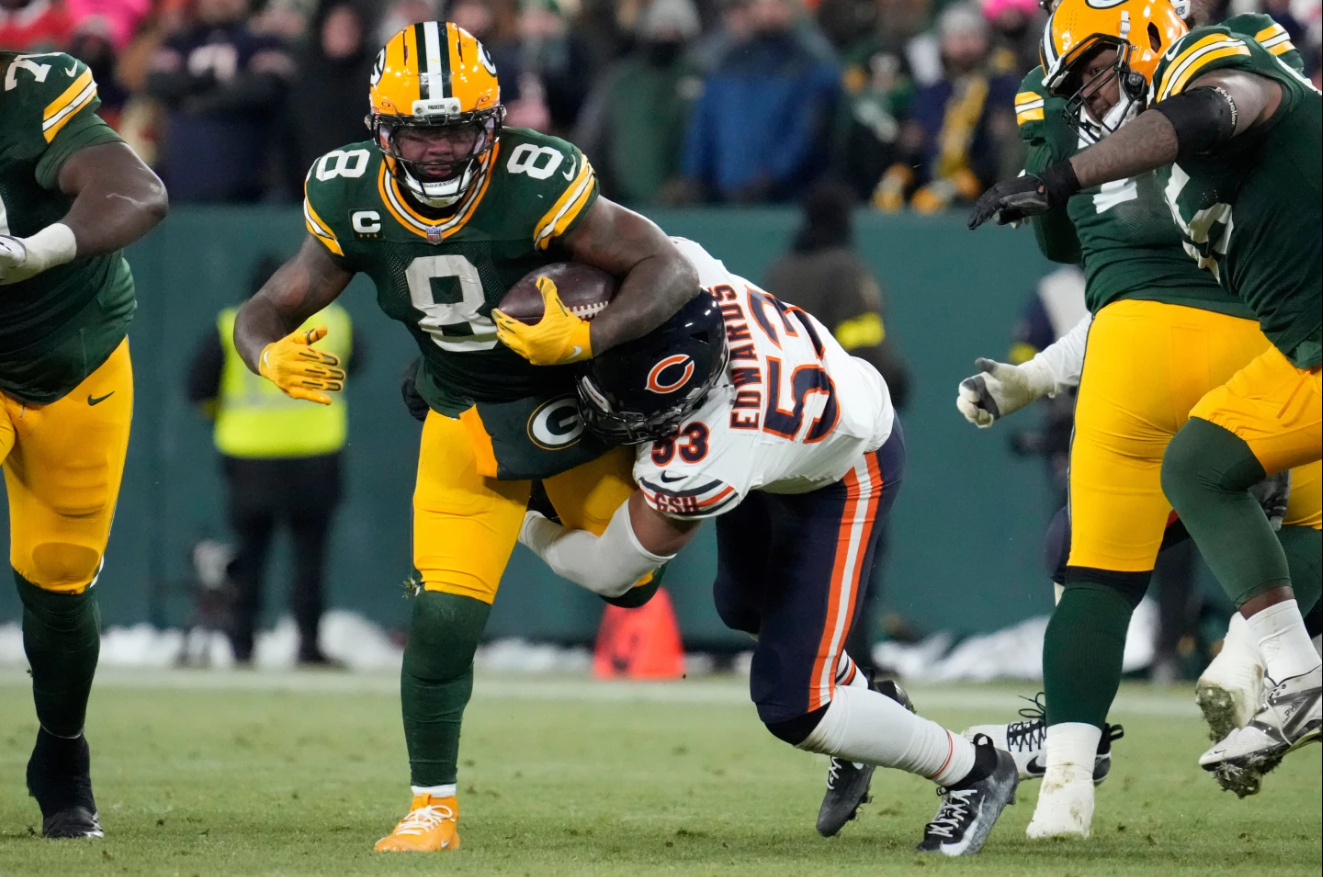 Chicago Bears linebacker T.J. Edwards (53) tackles Green Bay Packers running back Josh Jacobs (8) during the second half of an NFL football game Sunday, Dec. 7, 2025, in Green Bay.
