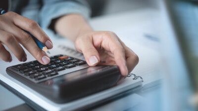 Hand using calculator