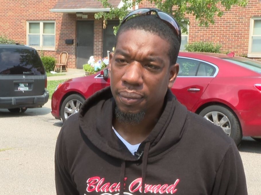 Daronce Daniels is pictured at Marianna Terrace. He's clean-shaven and wearing a black hooded sweatshirt.