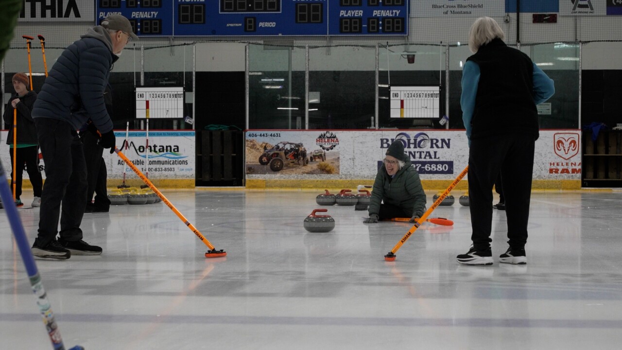 Curler falling but having fun