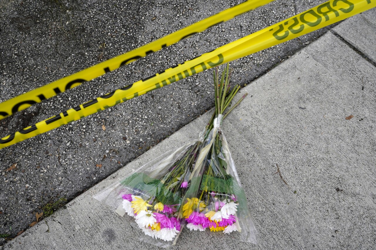 flowers on ground where men struck by truck at Wilton Manors Pride parade, June 20, 2021
