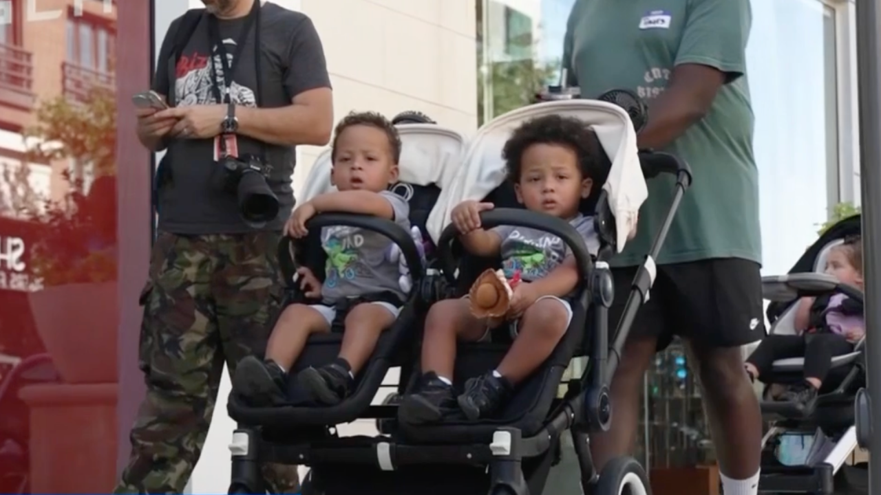 A dad from the Dallas Stroller Club pushing a stroller with his two sons