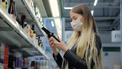 A woman looking at alcohol in a store