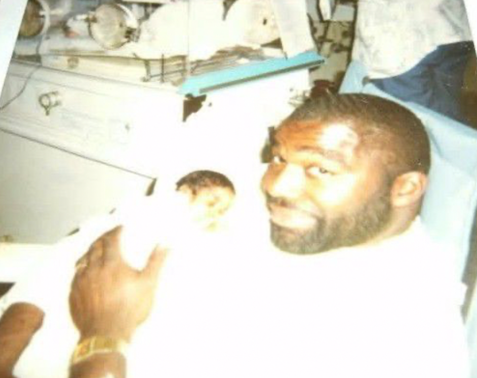Wyandotte County Sheriff's Deputy Elijah Ming held by his father as a newborn.