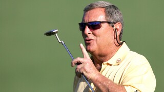 In this April 6, 2006, file photo, Fuzzy Zoeller encourages the crowd to be quiet on the second hole during first round play at the Masters golf tournament at the Augusta National Golf Club in Augusta, Ga. 