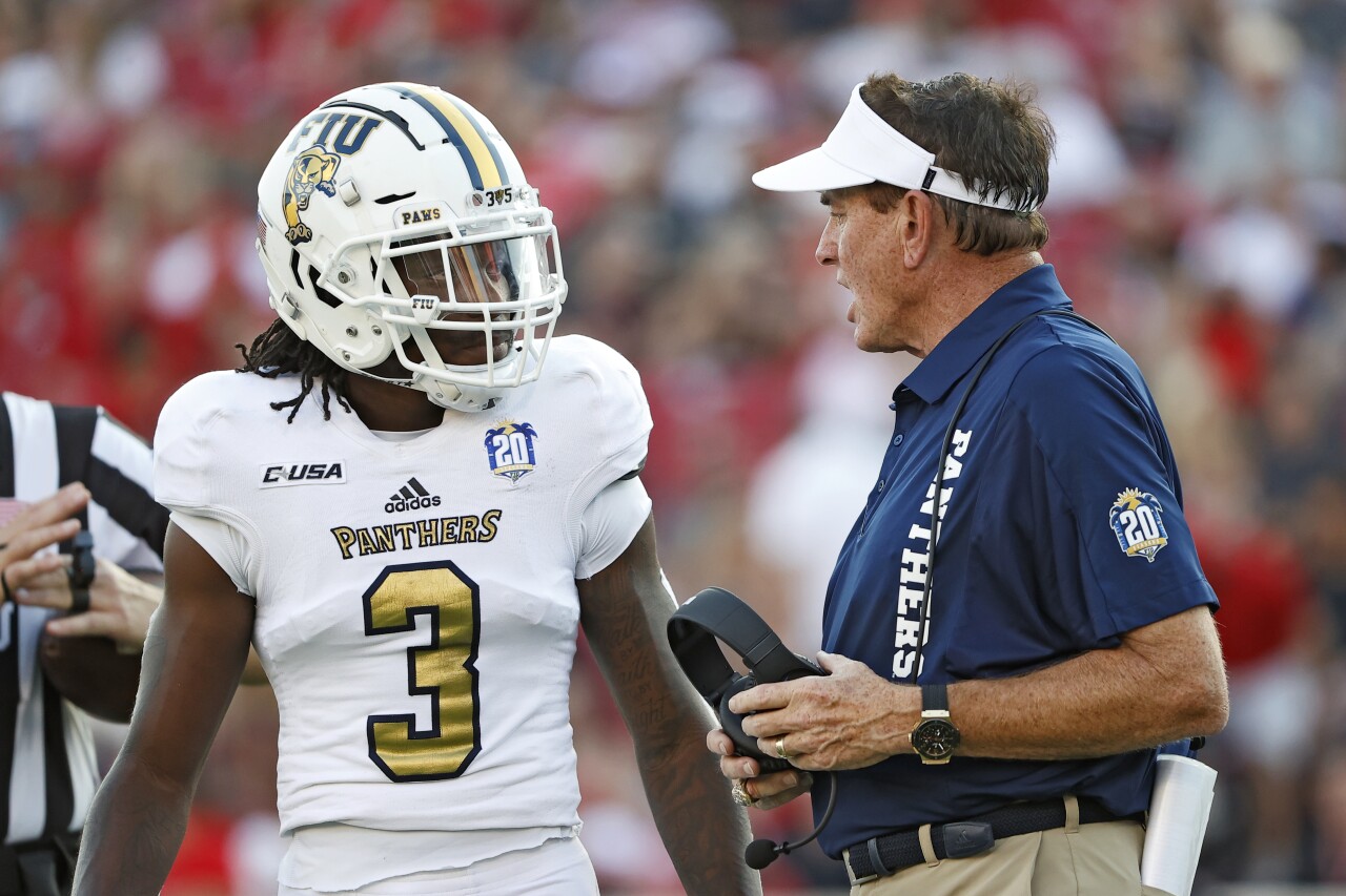 FIU Panthers head coach Butch Davis speaks to safety Richard Dames on sideline at Texas Tech in 2021