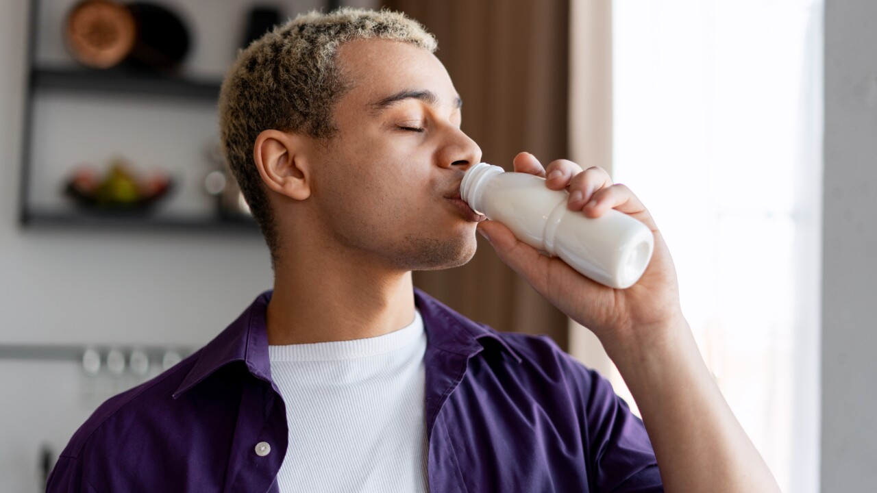 Young,Man,Drinking,A,Probiotic,Beverage,From,A,Bottle,,Focusing