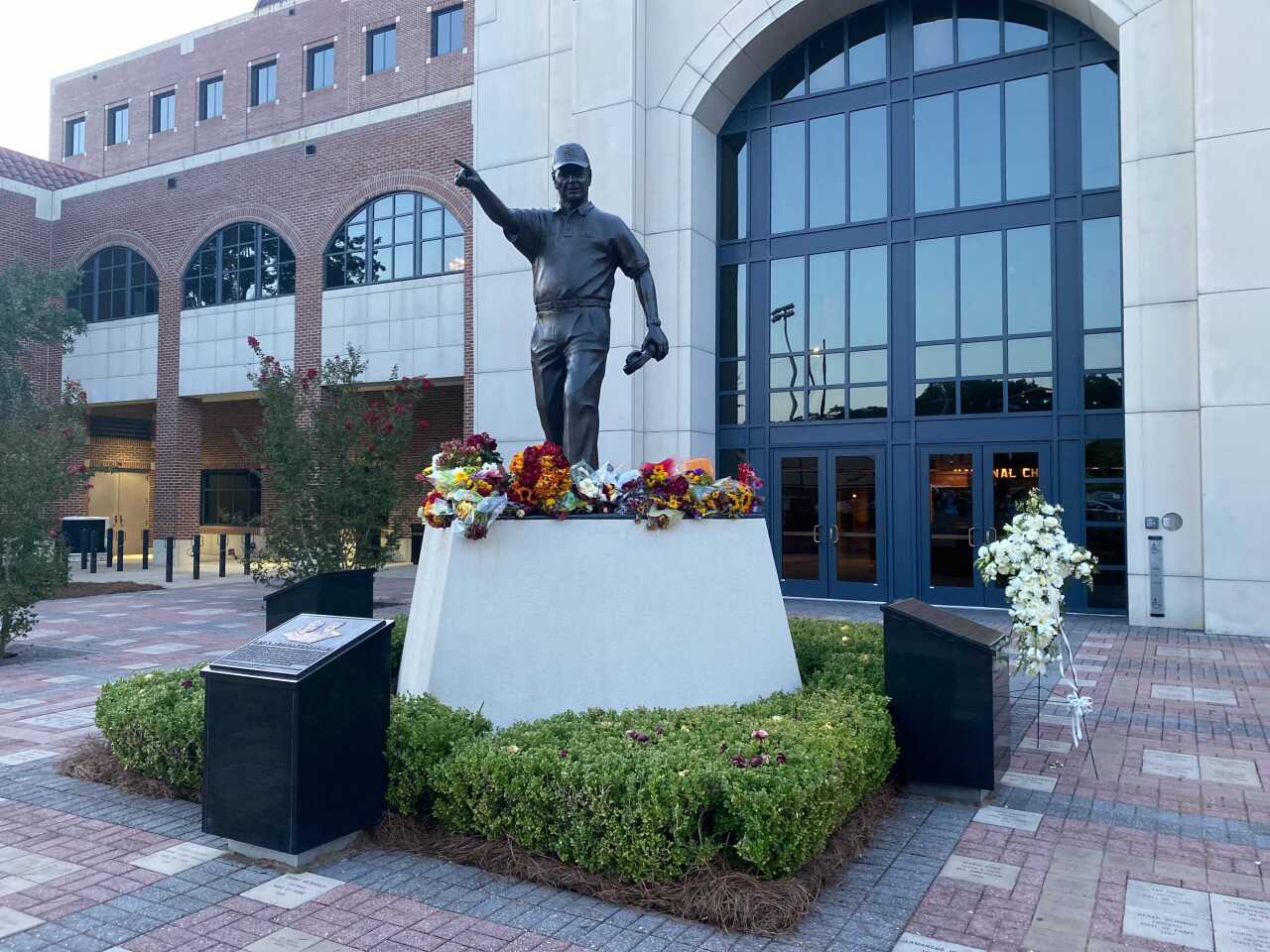 Flowers adorn Bobby Bowden statue outside Doak S. Campbell Stadium at Bobby Bowden Field, Aug. 14, 2021