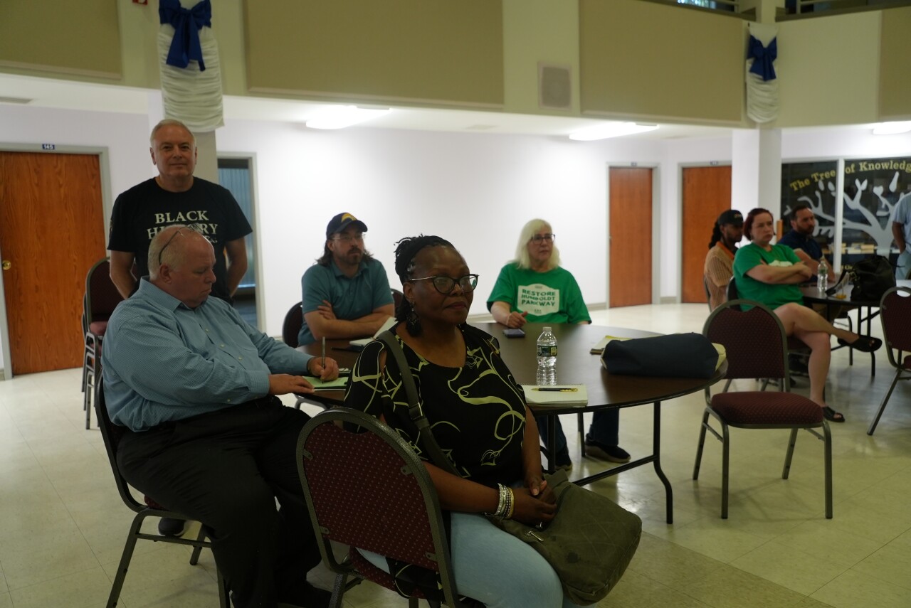 Neighbors are watching a presentation at the meeting