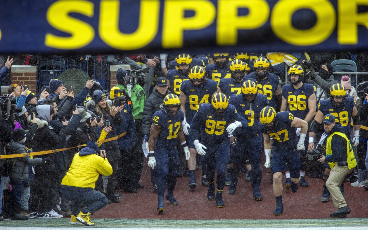 Michigan Wolverines players run out of tunnel at Michigan Stadium before game against Ohio State Buckeyes, Nov. 27, 2021
