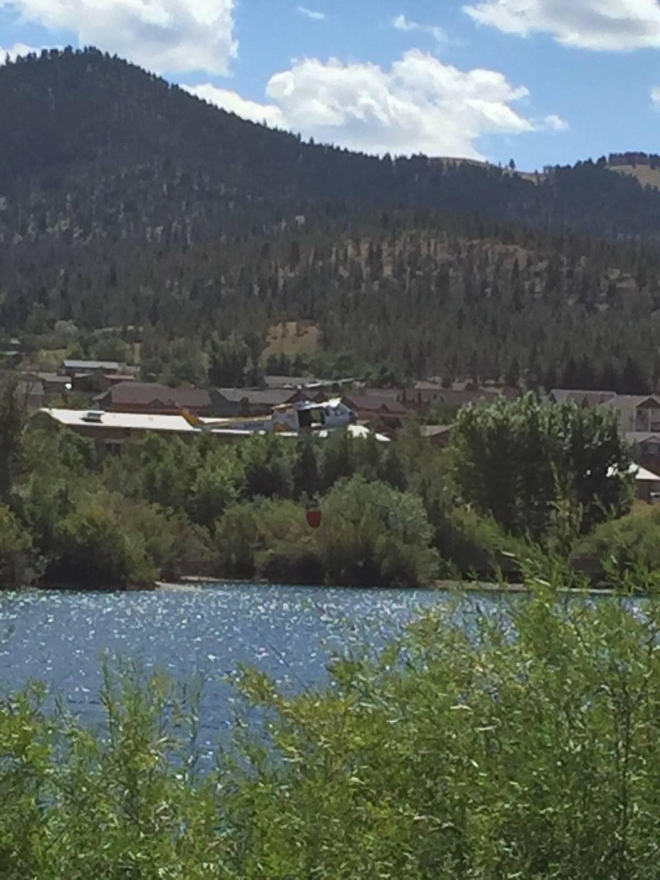 DNRC helicopter getting water from spring meadow