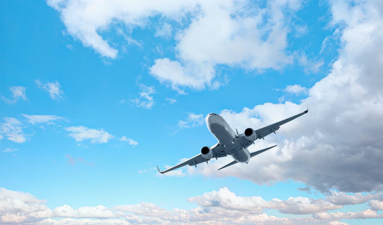 White,Passenger,Airplane,Flying,In,The,Sky,Amazing,Clouds,In
