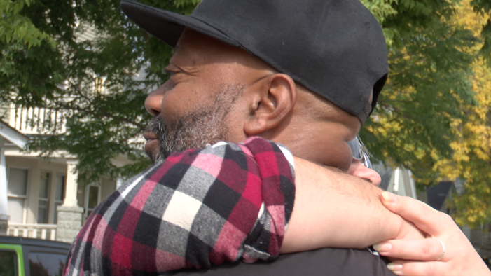 Riverwest community resident hugs Mailman Mike