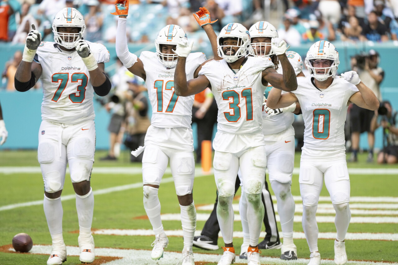 Miami Dolphins running back Raheem Mostert celebrates after scoring TD vs. Carolina Panthers with offensive lineman Austin Jackson, receiver Jaylen Waddle, offensive lineman Robert Hunt and receiver Braxton Berrios, Oct. 15, 2023