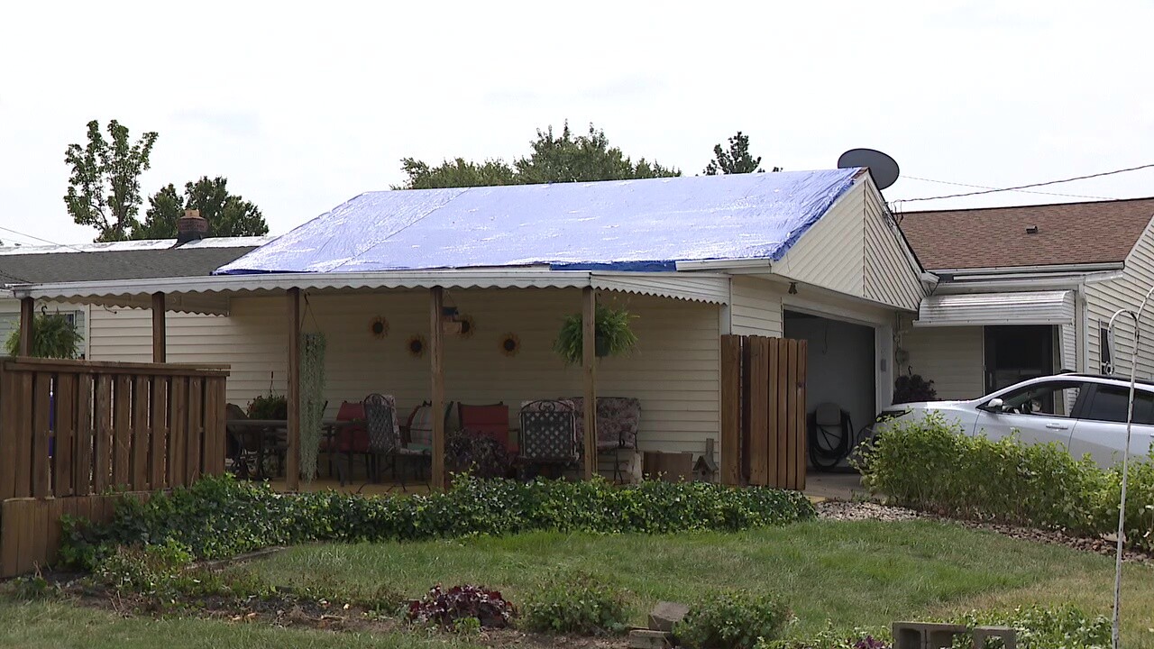 A tarp covers Karen Rieker's damaged roof in Brook Park.