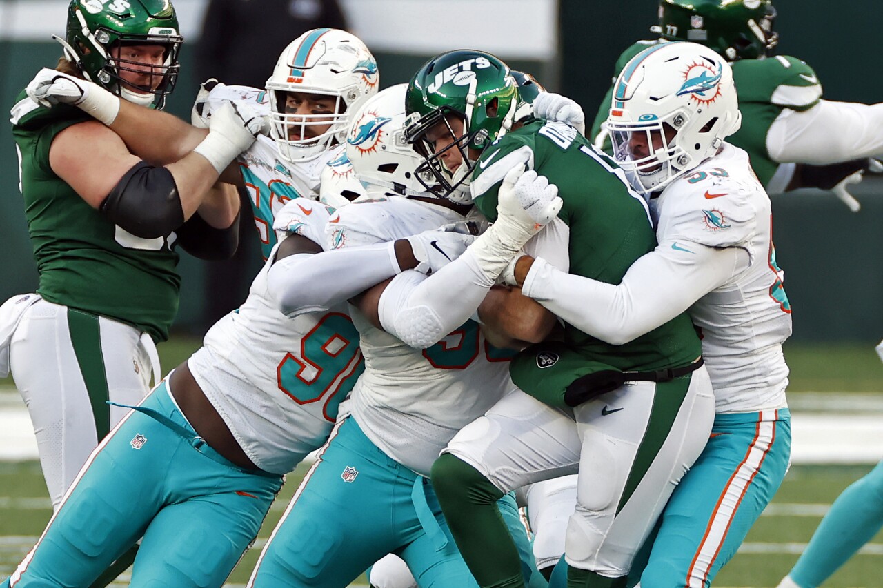 New York Jets QB Sam Darnold sacked by Miami Dolphins defenders in November 2020