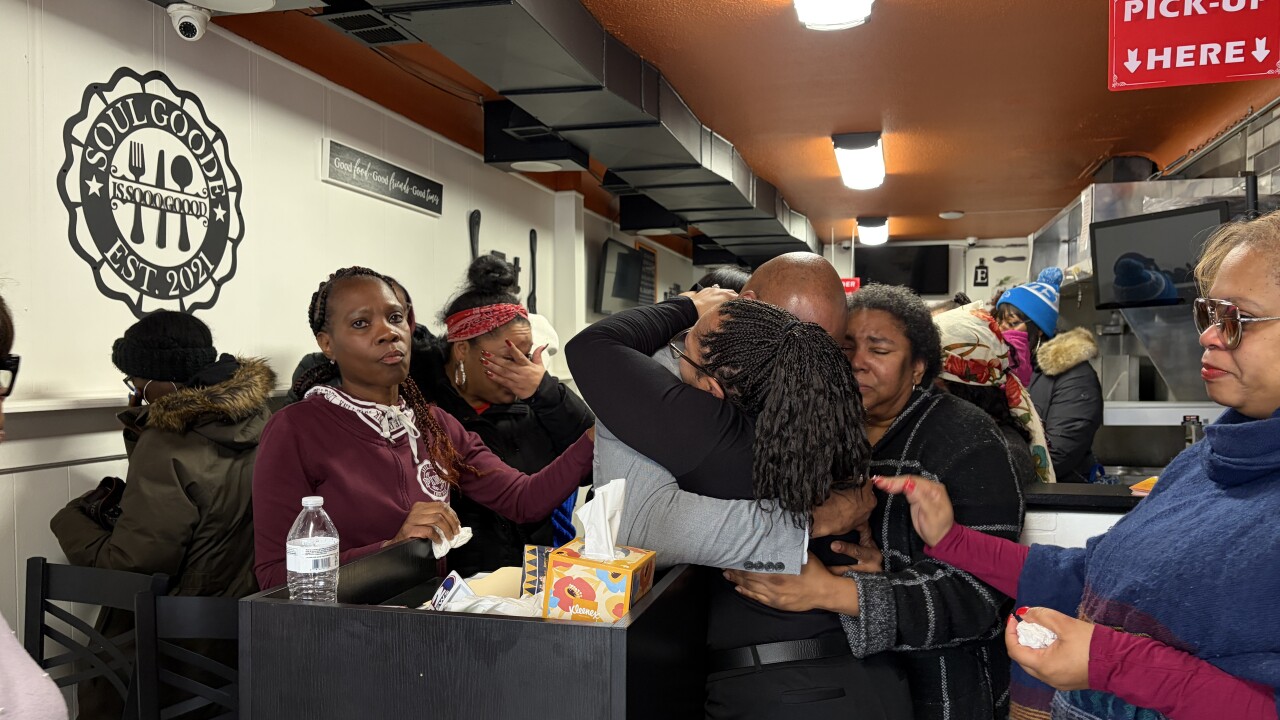 Friends and family comforting one another in the wake of Mucari Finley's death