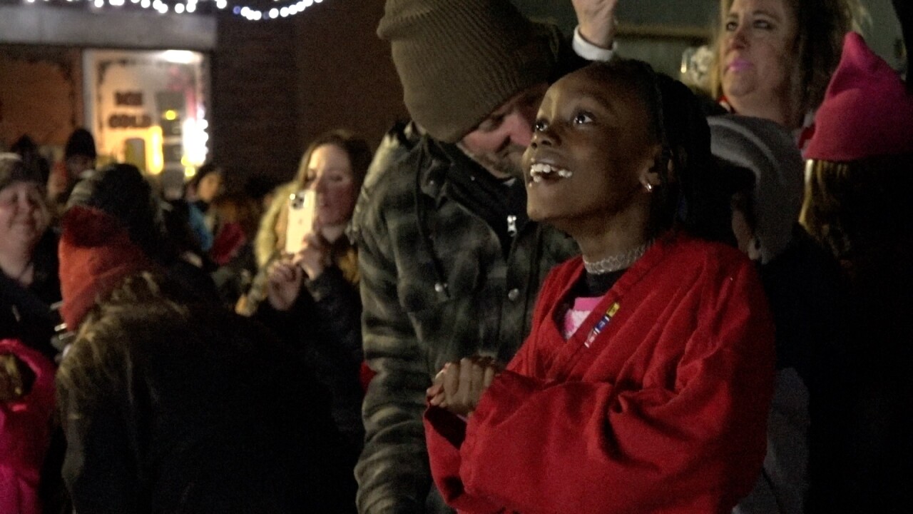 The reaction of a young lady after they lit up the tree