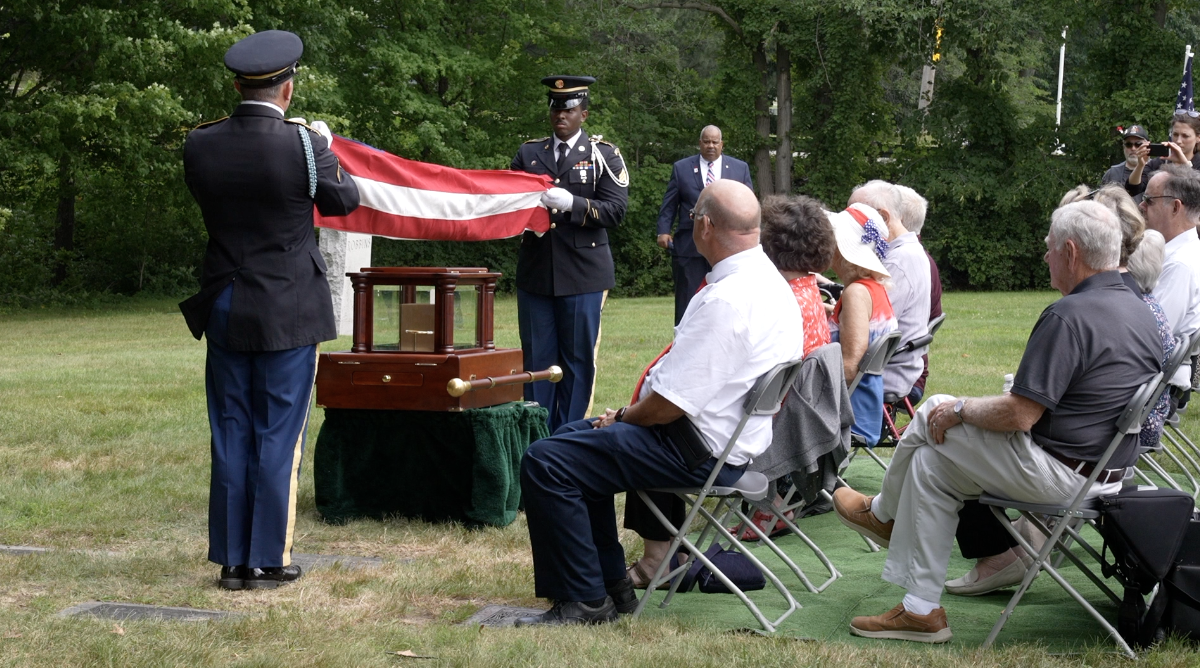 Soldiers were at the burial, folding the flag to present to Parker's family