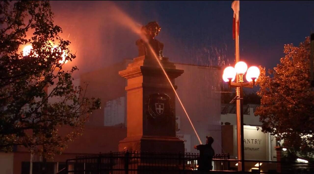 Pueblo Fire Department cleaning up the Christopher Columbus statue in Pueblo on Sunday morning