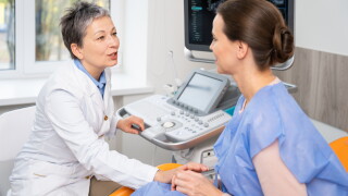 A,Doctor,And,Patient,Converse,During,An,Ultrasound,Appointment,,With