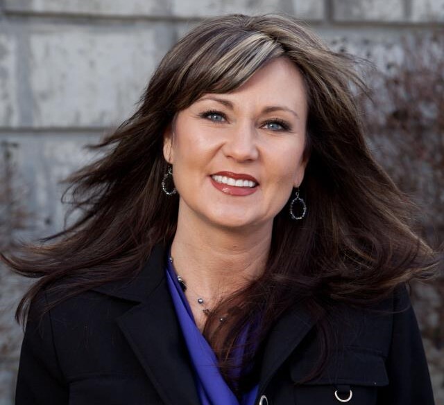 Leisa Spears Mulcahy is vice president of workforce at the Northern Kentucky Chamber of Commerce. In this portrait, she is wearing a blue top and black coat.