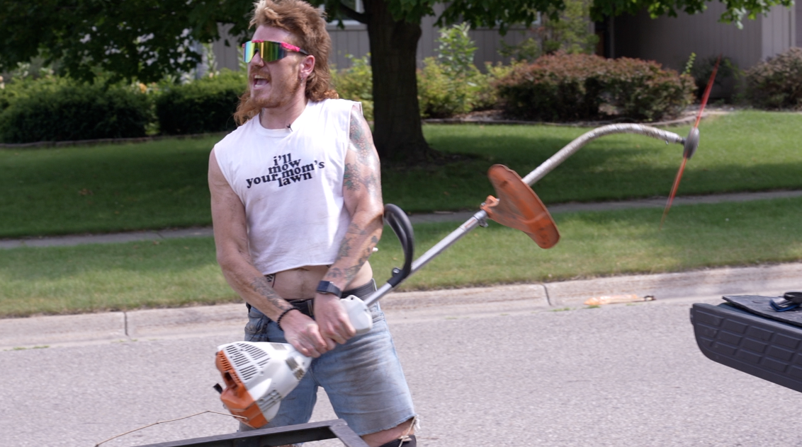 Guy with a mullet landscaping