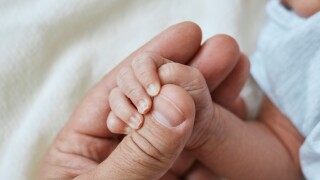 Close-up,Little,Hand,Of,Child,And,Finger,Of,Father,,Newborn