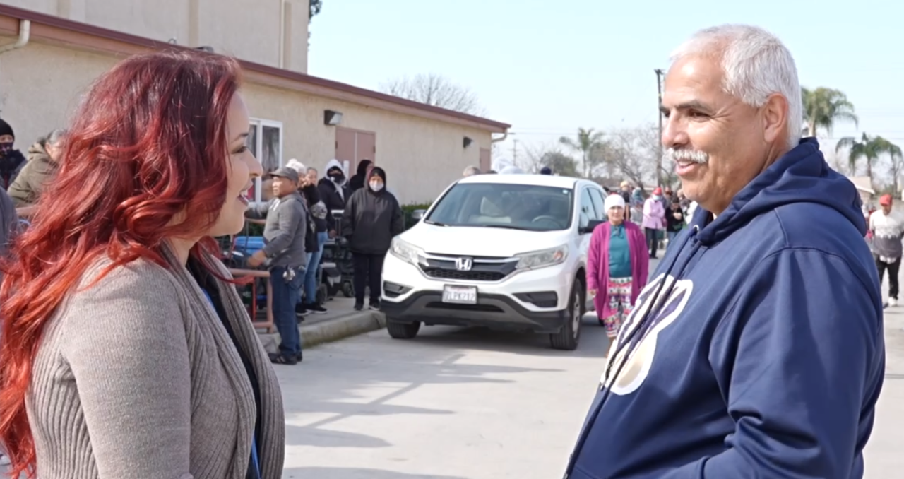 23ABC Neighborhood News Reporter Ruby Rivera interviewing food drive volunteer Mario Nunez