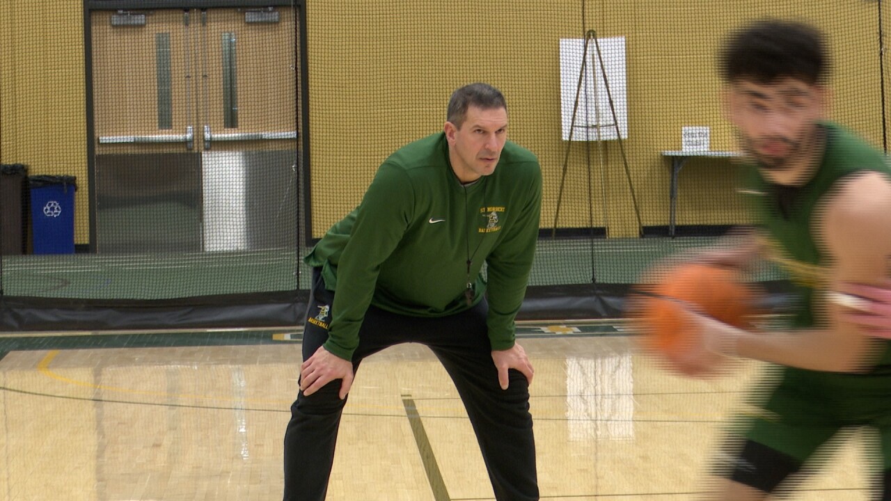 ST. NORBERT BASKETBALL COACH GARY GRZESK LOOKS ON AT A PRACTICE EARLIER THIS YEAR.