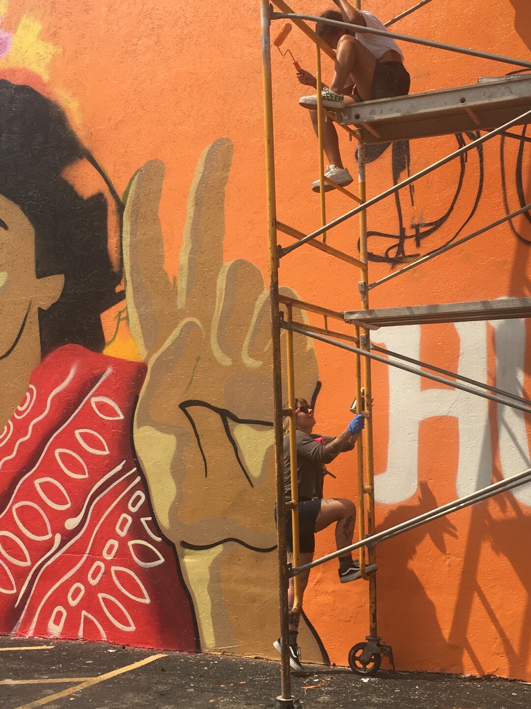 Nyia Luna and GirlMobb painting the Dolores Huerta mural