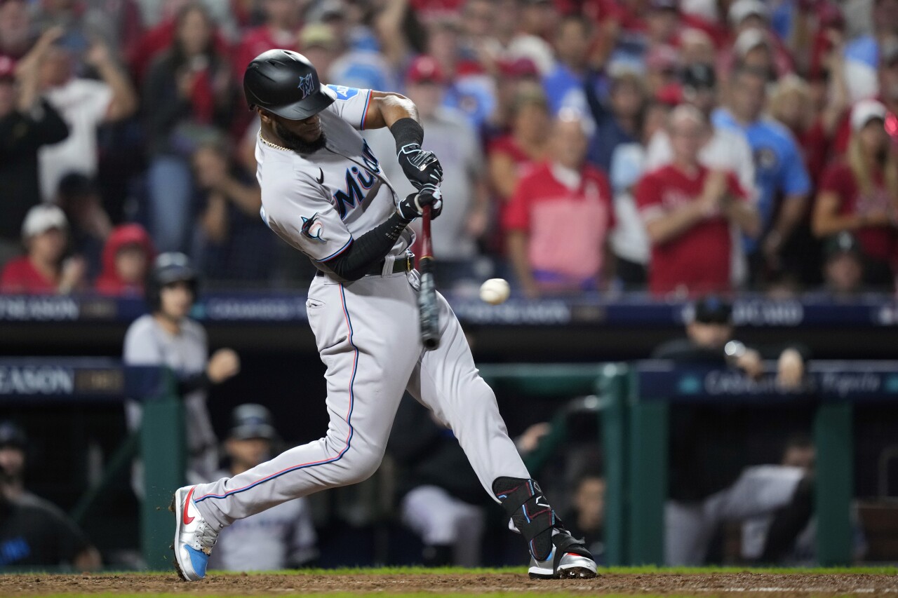 Miami Marlins outfielder Bryan De La Cruz hits run-scoring single against Philadelphia Phillies pitcher Zack Wheeler during seventh inning of Game 1 in NL wild-card playoff series, Tuesday, Oct. 3, 2023