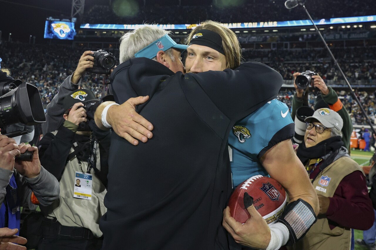 Jacksonville Jaguars head coach Doug Pederson hugs QB Trevor Lawrence after AFC wild-card playoff win against Los Angeles Chargers, Jan. 14, 2023