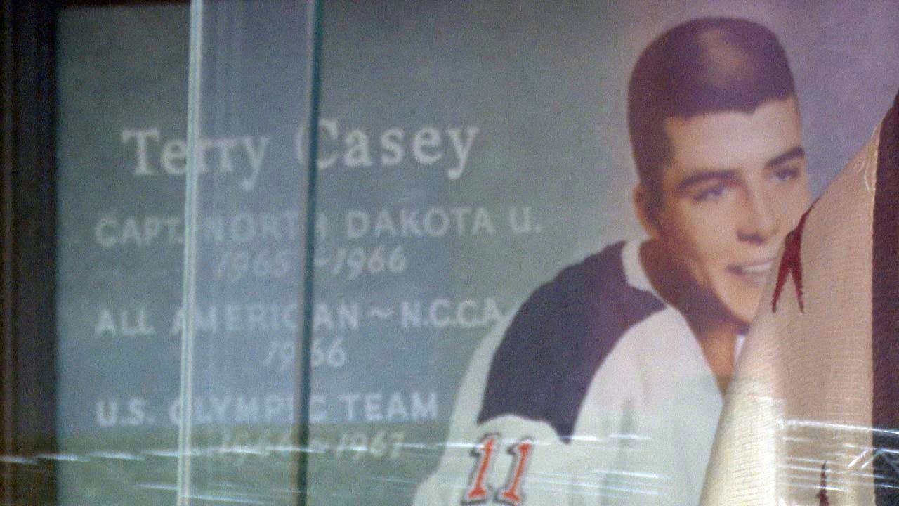 A display case with two of Casey's jerseys and pictures of Casey is mounted on the wall inside the Great Falls Ice Plex
