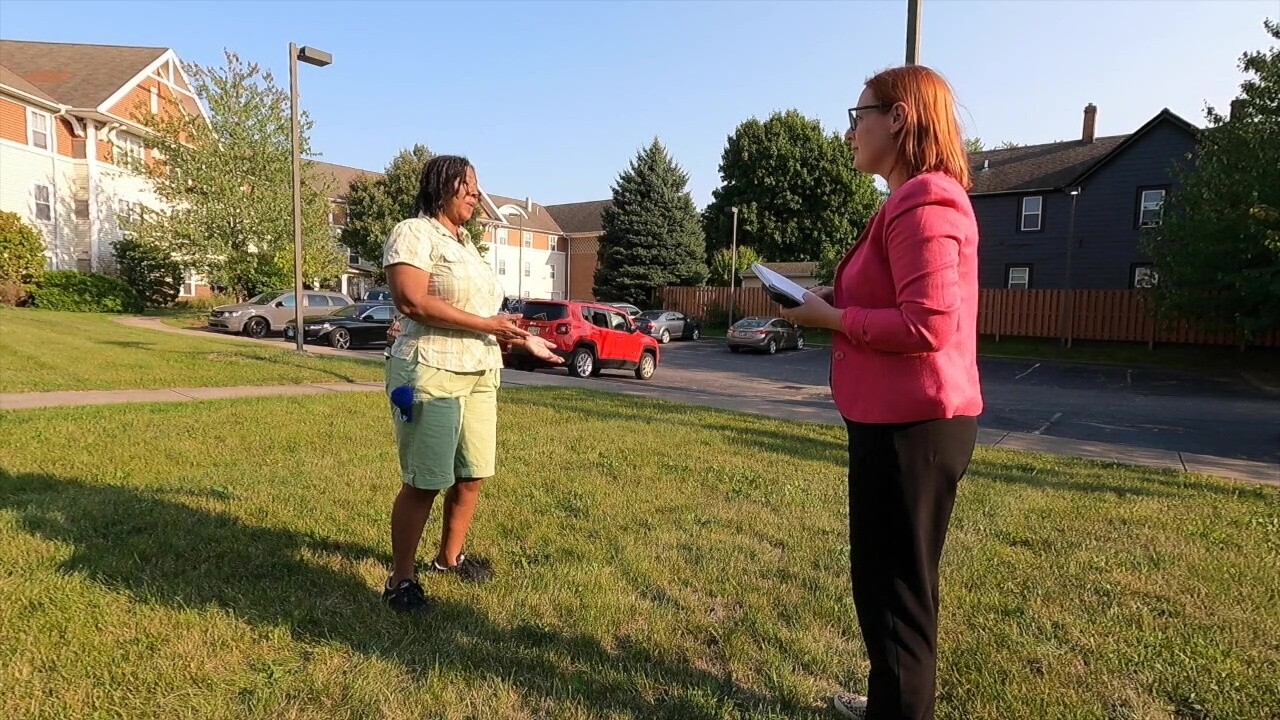 Wealthy Gibson, left, talks to News 5 reporter Michelle Jarboe outside the Broadway Place apartments.