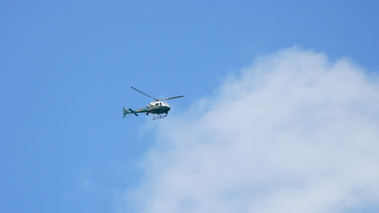 Helicopter circling over Blind Pass looking for the missing swimmer.