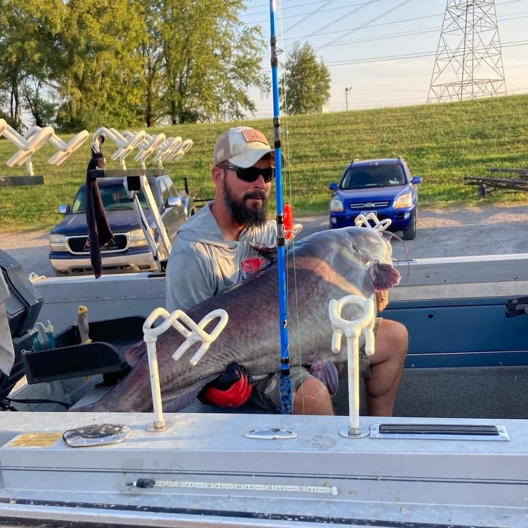 guy who caught big huge blue cat fish. with his fish