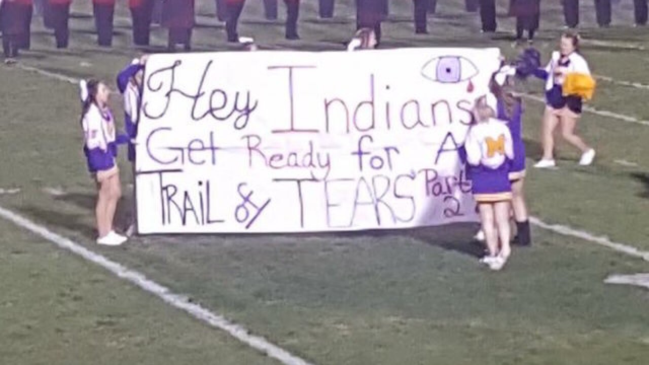 Cheerleaders Trail Of Tears Banner At High School Football Game