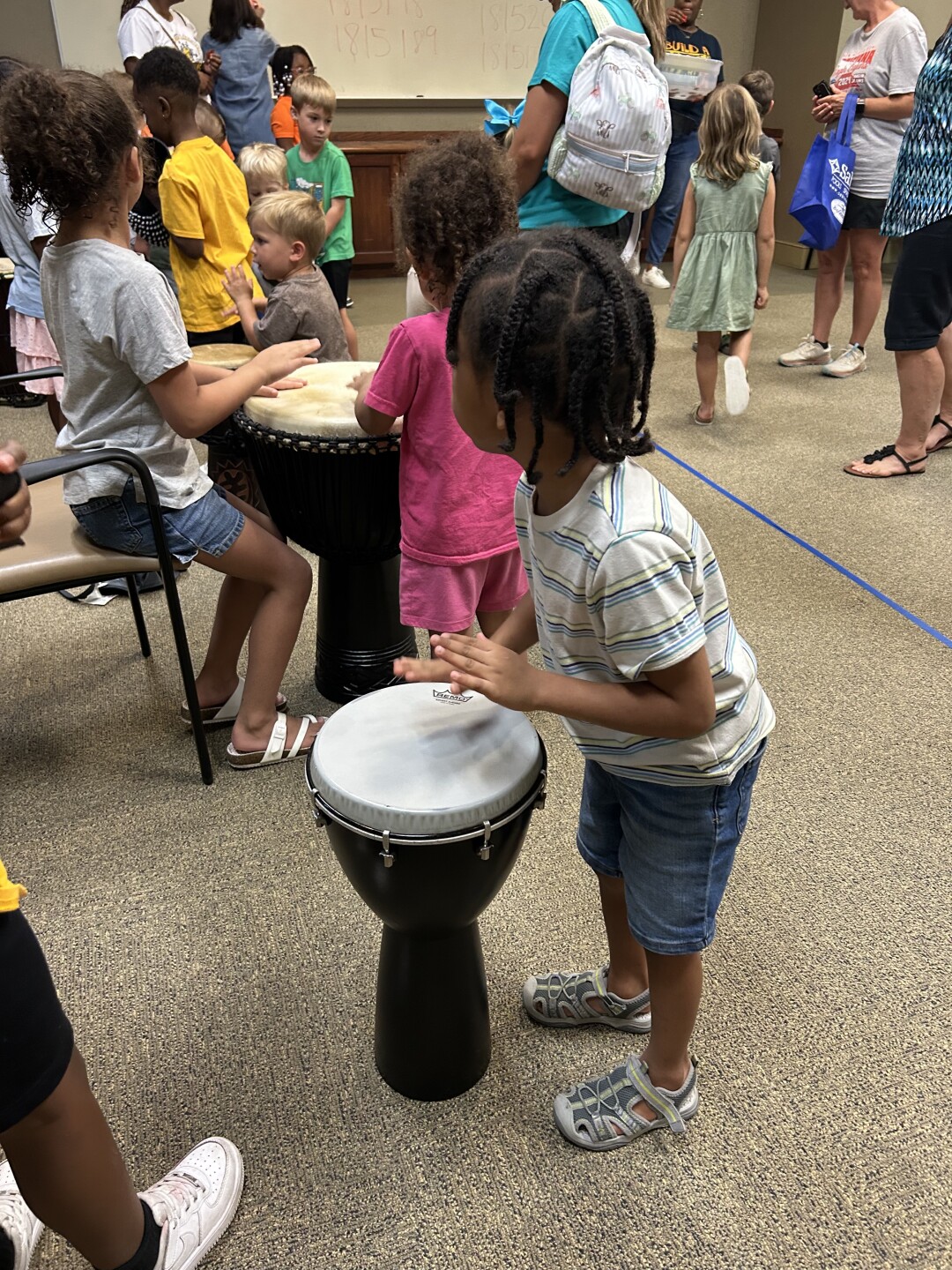 Local children playing the drums post performance