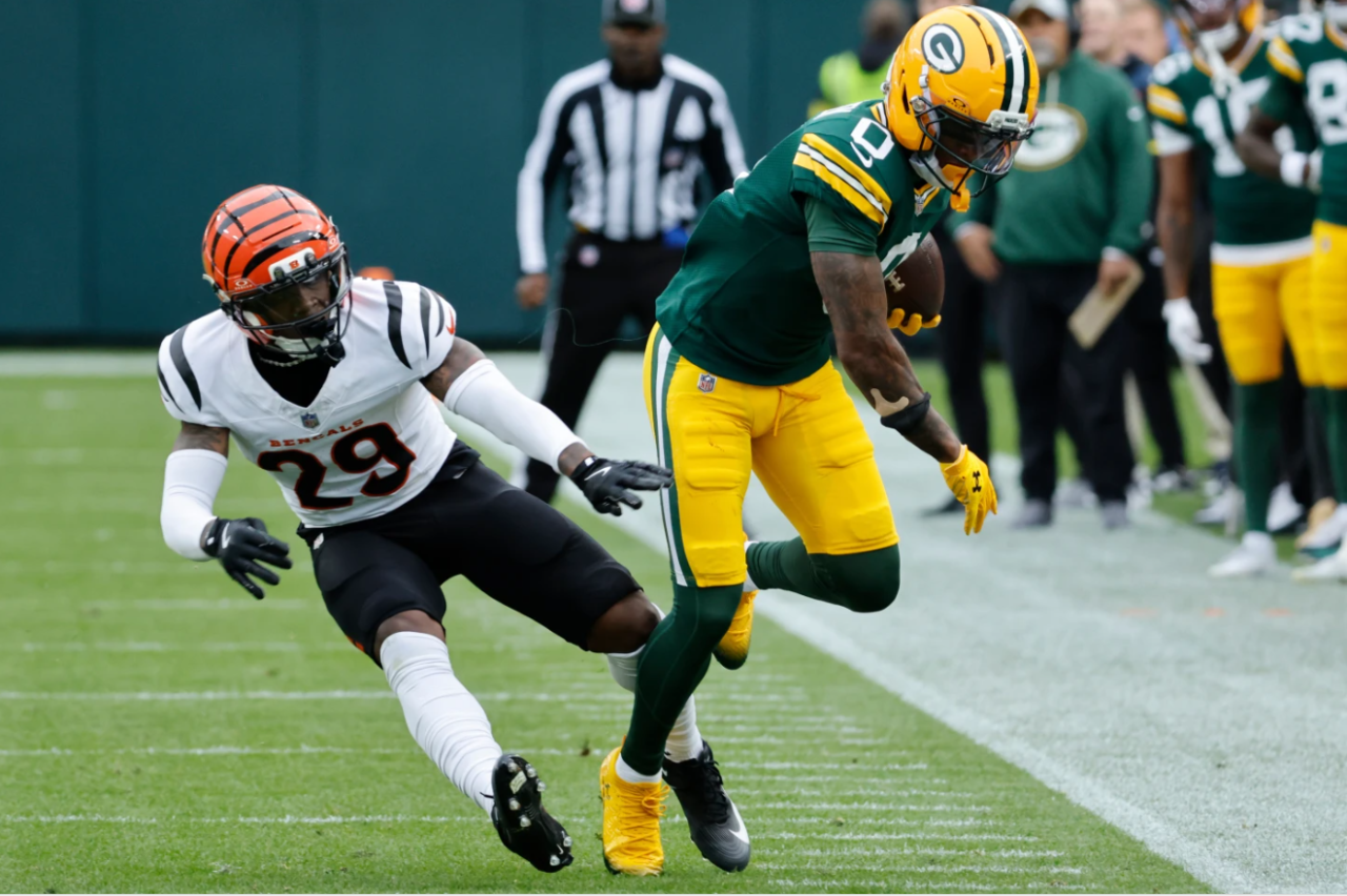 Green Bay Packers wide receiver Matthew Golden (0) runs after a catch against Cincinnati Bengals cornerback Josh Newton (29) in the first half of an NFL football game, Sunday, Oct. 12, 2025, in Green Bay, Wis.