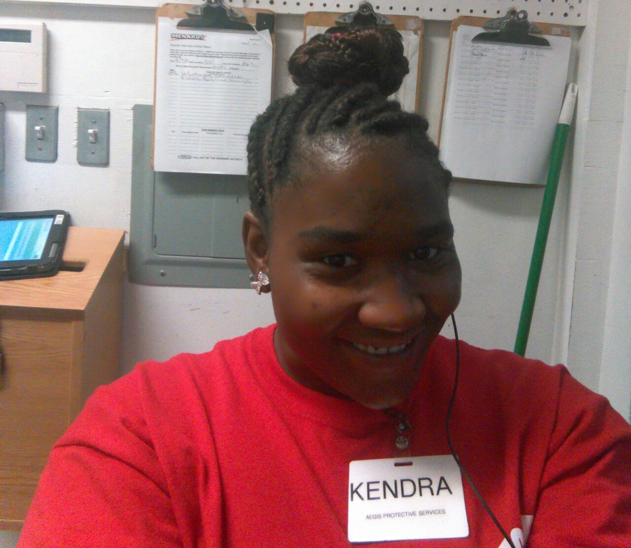 Kendra Davis smiles in this undated photo taken while she was at work. Her braided hair is wrapped in a bun atop her head, and she's wearing a red shirt.