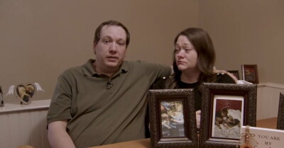 The Zylk Family with a photo of their dog.